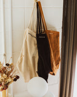 Routine Corduroy Tote Bags Hanging on a coat hook - Available in three colours - Brown, Clean and Black